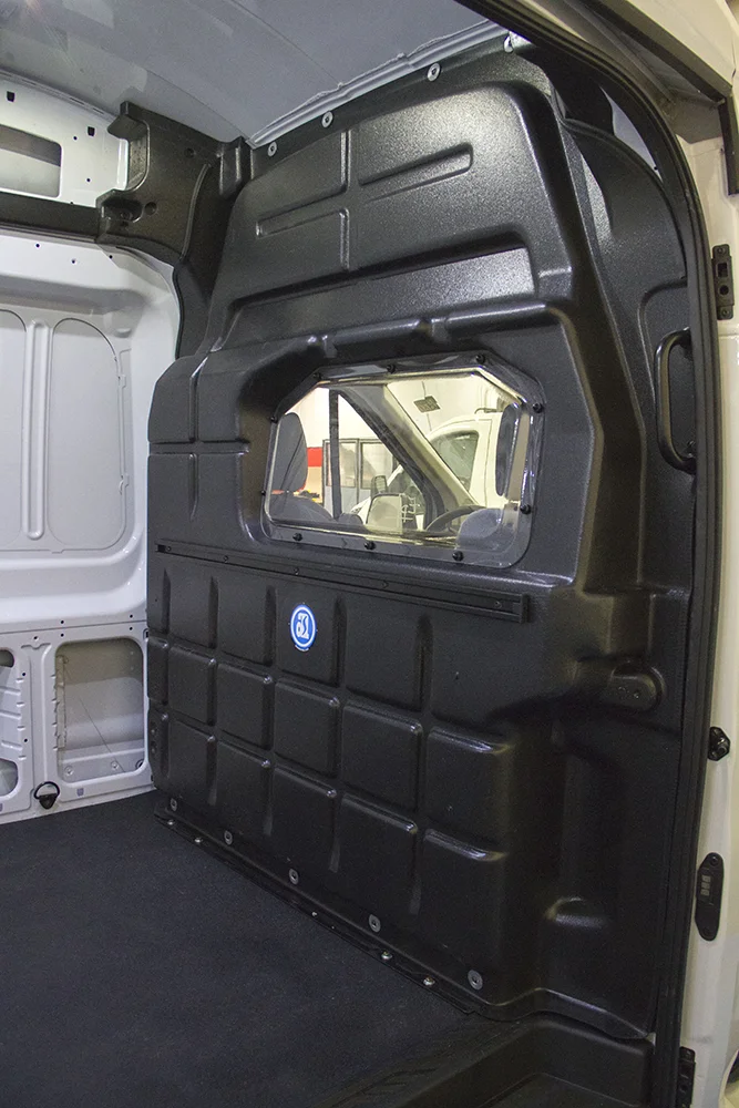 A composite van bulkhead partition mounted in place