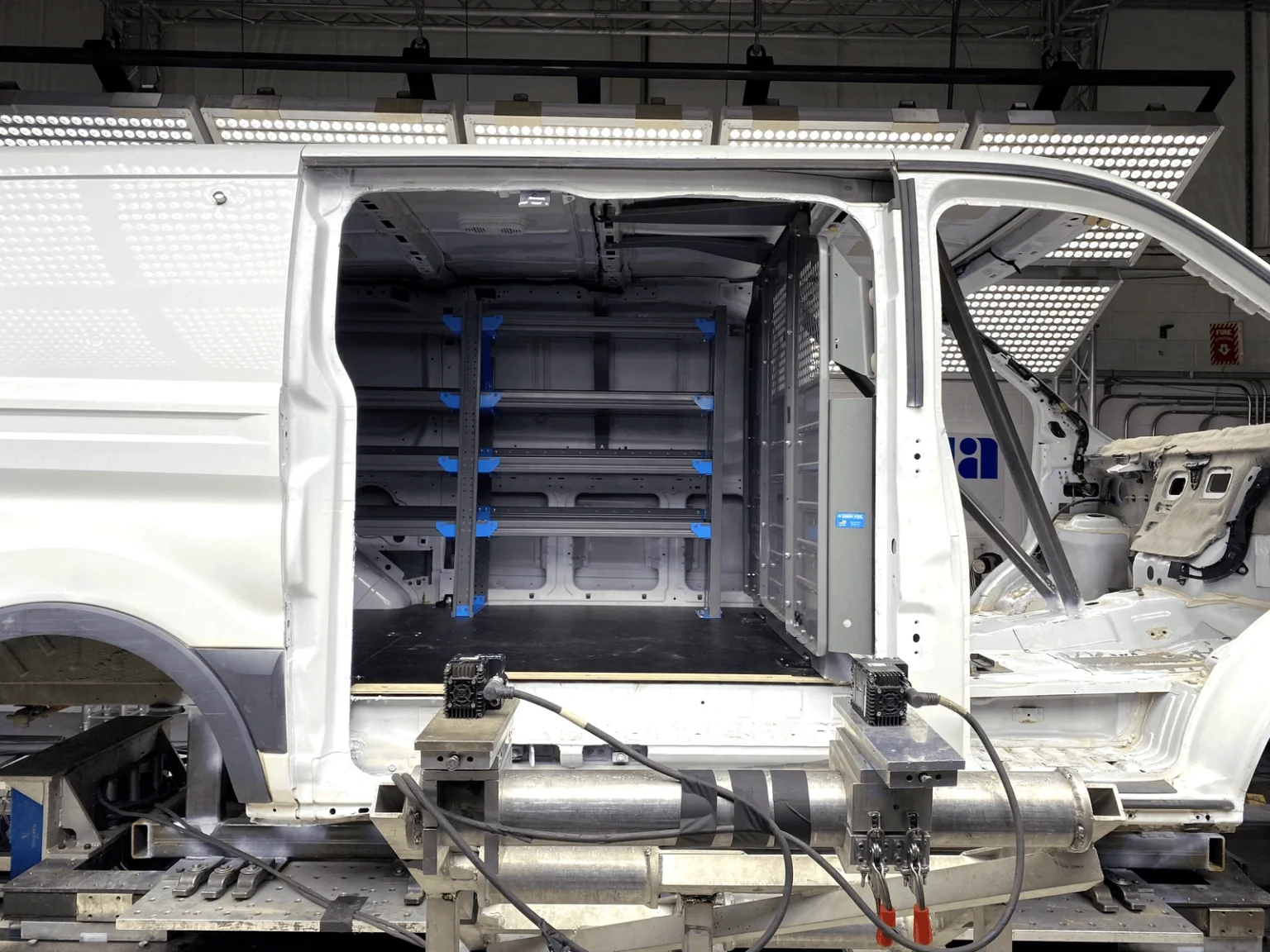 A stripped down van showing equipment mounting points