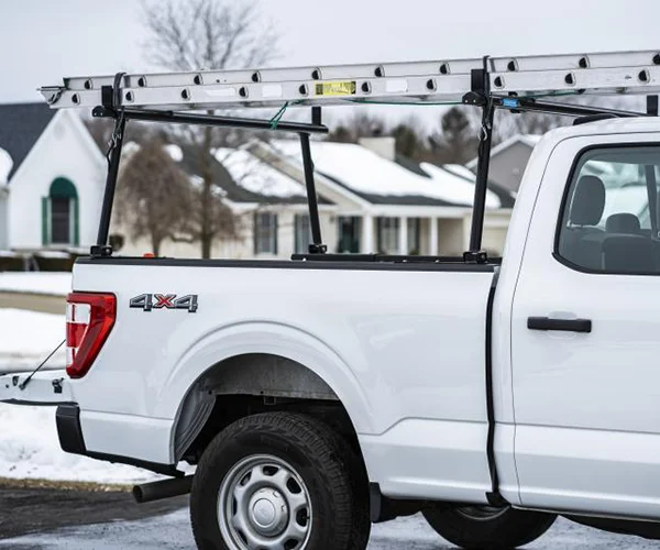 Truck rack on a white pickup with a ladder mounted on top